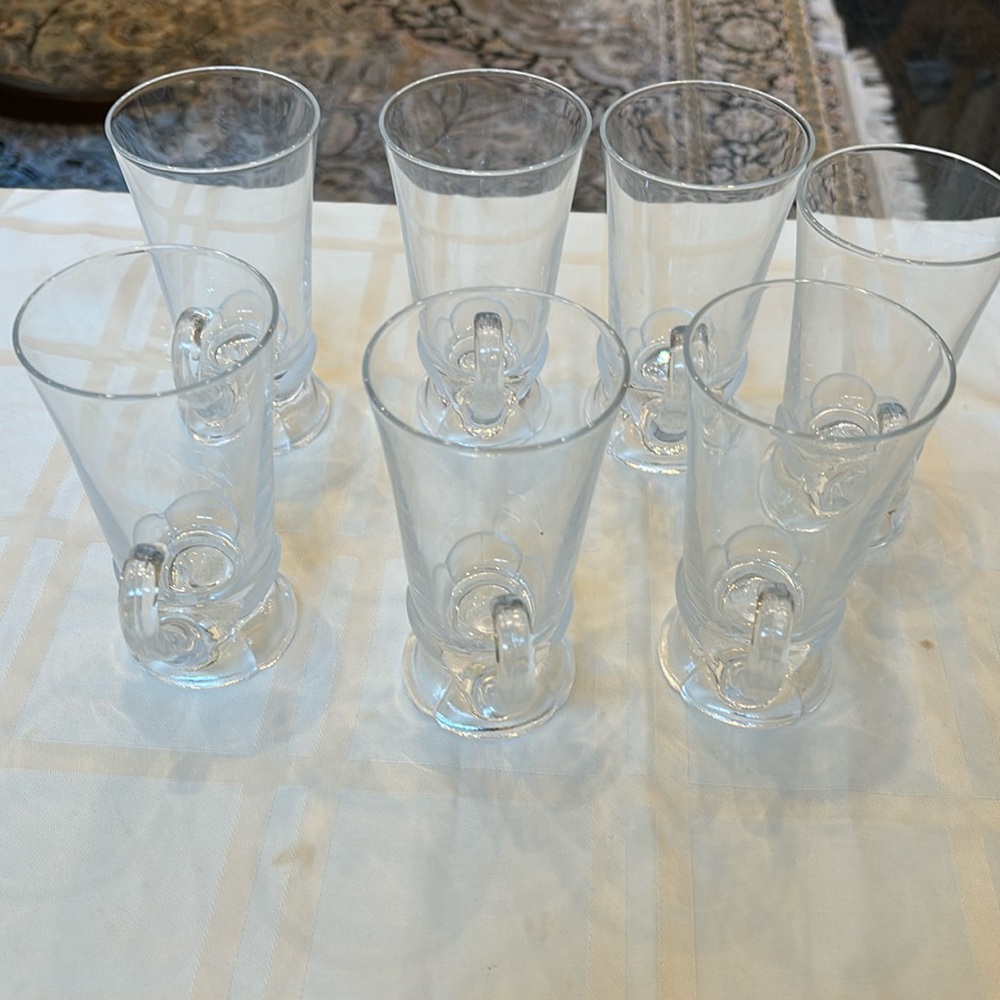 A set of 7 pedestal glass cups for cold drinks with the handle.